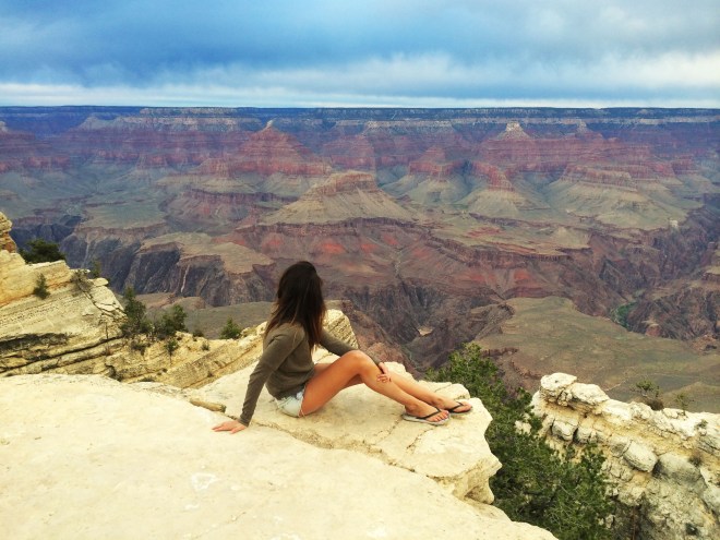Girl sitting in front of grand canyon