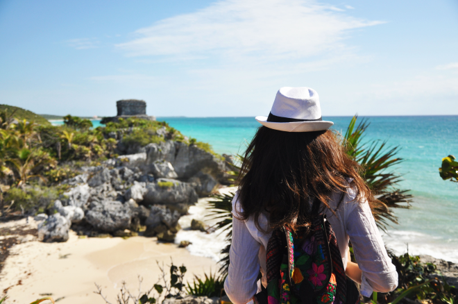 Girl in front of tulum mayan ruins