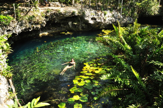 Girl in pond with lily pads