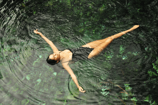 Girl floating in cenote