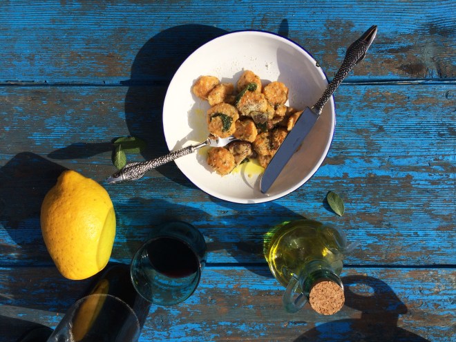 Home-made pumpkin gnocchi with lemon and sage on blue table