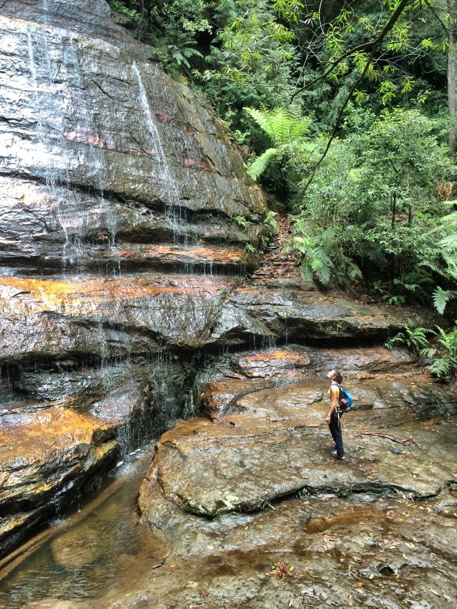 Girl under waterfall at blue mountains