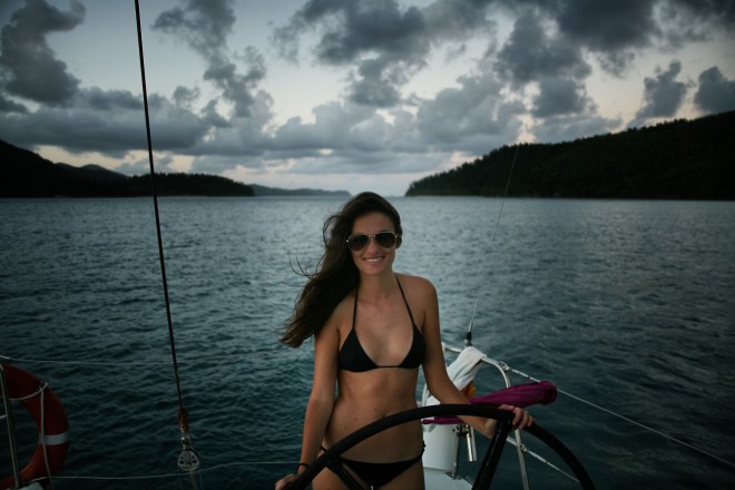 Girl sailing boat Whitsunday islands sunset