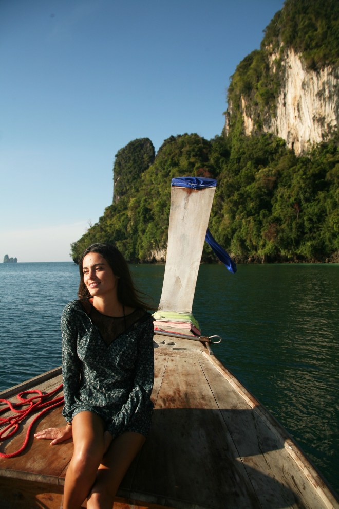 girl on longtail boat with rocks thailand