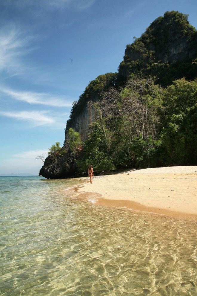 Girl on beach with rocks thailand