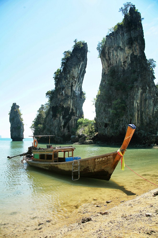 longtail boats with rocks thailand