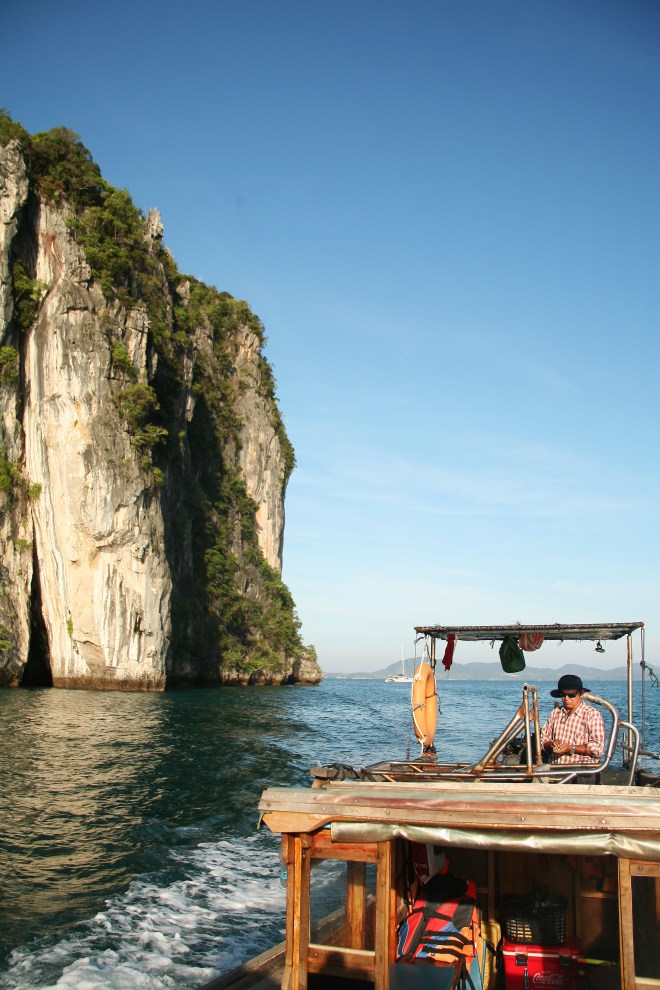 fisherman on longtail boat thailand