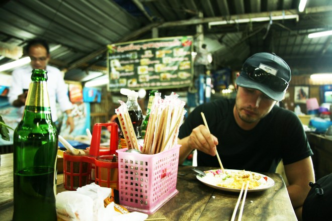 man eating noodles in thailand
